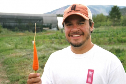 Chef Nate King holds up carrot at Rendezvous Farm